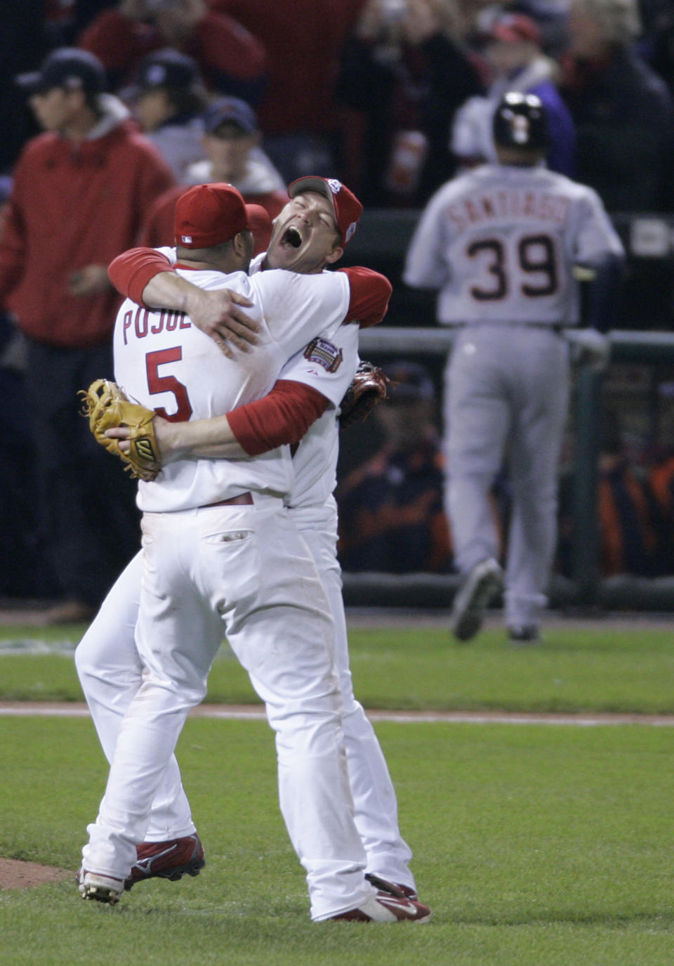 FILE - St. Louis Cardinals Scott Rolen and teammate Albert Pujols celebrate as Detroit Tigers Ramon Santiago walks off the field after the St. Louis Cardinals defeated Detroit Tigers in Game 5 of the World Series in St. Louis, Oct. 27, 2006. Rolen could become just the 18th third baseman elected to baseball's Hall of Fame, the fewest of any position. Rolen, Todd Helton and Billy Wagner are the leading contenders in the Baseball Writers' Association of America vote announced Tuesday, Jan. 24, 2023.(AP Photo/Tom Gannam, File)