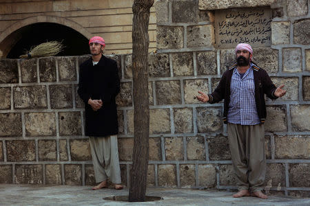 Yazidi men pray at a Yazidi temple in Lalish, Shikhan province, Kurdistan, northern Iraq, December 7, 2016. REUTERS/Ari Jalal