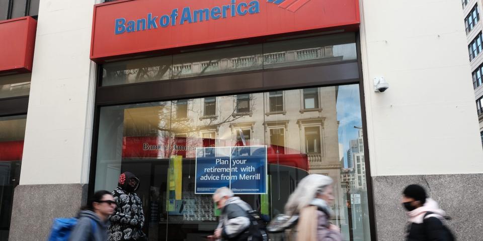 People walking by a Bank of America branch