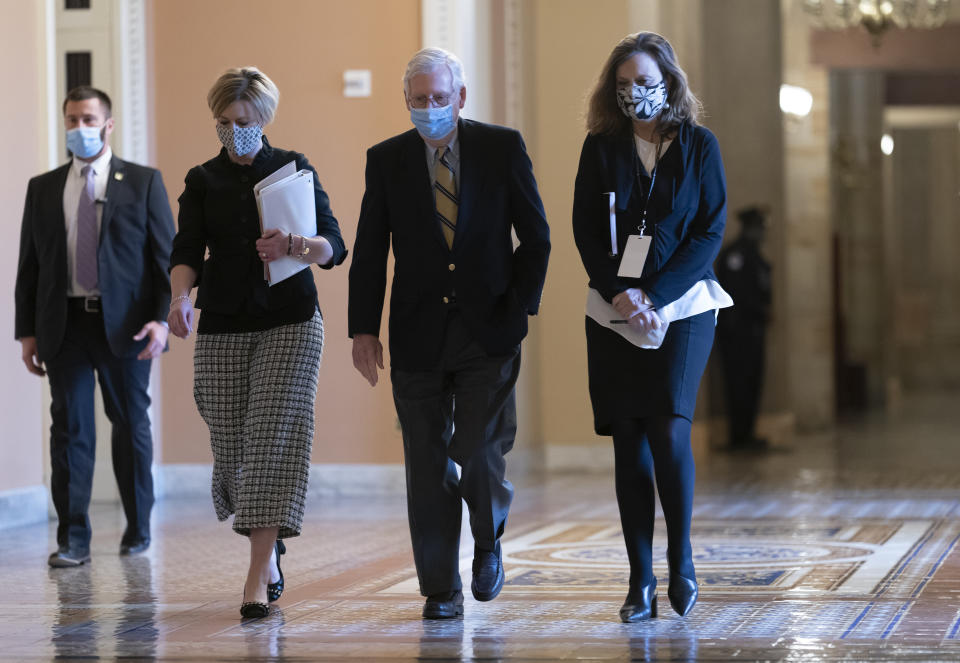 Senate Minority Leader Mitch McConnell, R-Ky., returns to the chamber after the Senate voted to consider hearing from witnesses in the impeachment trial of former President Donald Trump, at the Capitol in Washington, Saturday, Feb. 13, 2021. (AP Photo/J. Scott Applewhite)