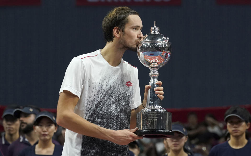 Daniil Medvedev of Russia kisses his champion trophy during the award ceremony of the Japan Open men's tennis tournament in Tokyo Sunday, Oct. 7, 2018. Medvedev defeated Kei Nishikori of Japan. (AP Photo/Eugene Hoshiko)