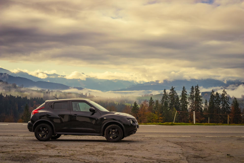 Doren, Austria - November 1, 2019: Black colored 2011 Nissan Juke car parking next to the road on a warm, cloudy autumn morning in a rural area in Vorarlberg, Austria.