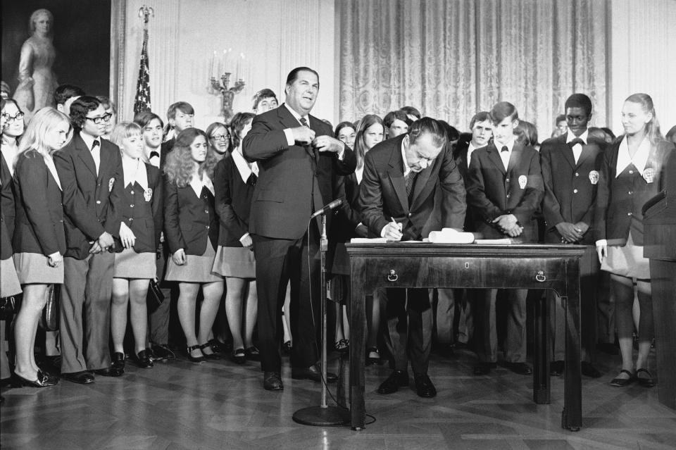 FILE - President Richard Nixon signs the Constitution's newest amendment which guarantees 18-year-olds the right to vote in all elections in East Room of the White House in Washington on July 4, 1971. Robert Kunzig, general services administrator, waits to certify officially ratification of the 26th amendment. Paul Larimer of Concord, Calif., a member of the singing group "Young Americans" also signed the amendment. (AP Photo/Charles Tasnadi, File)