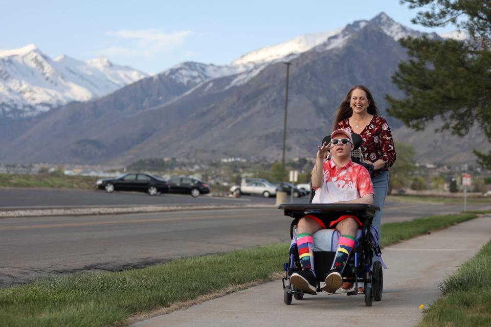 Jennifer May takes her son Stockton, 21, on a walk while visiting him at the Utah State Developmental Center, where he lives, in American Fork on Monday, May 1, 2023. Stockton has Dravet syndrome, a severe form of epilepsy. | Kristin Murphy, Deseret News