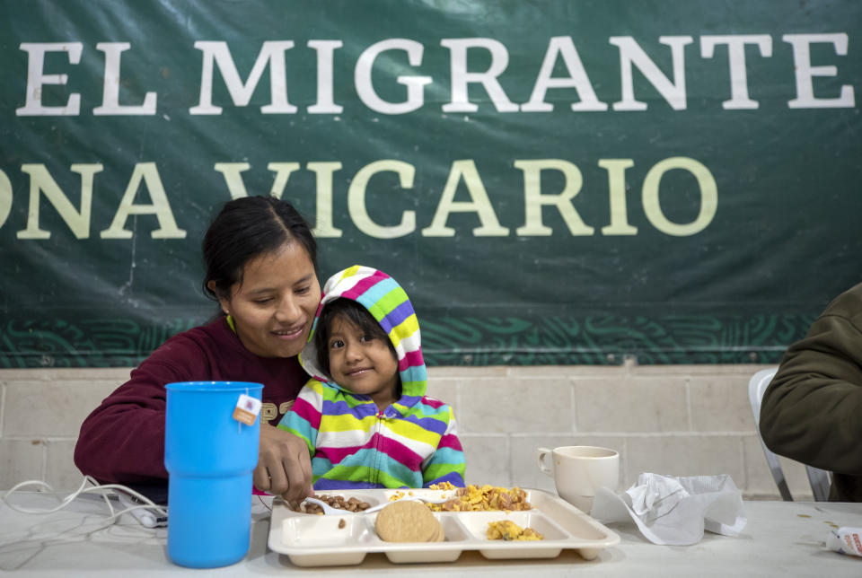 Guatemalan migrant Maudelina Geronimo feeds her three-year-old daughter Lisbeth at a government run shelter in Ciudad Juarez, Mexico, Sunday, Dec. 18, 2022. Texas border cities were preparing Sunday for a surge of as many as 5,000 new migrants a day across the U.S.-Mexico border as pandemic-era immigration restrictions expire this week, setting in motion plans for providing emergency housing, food and other essentials. (AP Photo/Andres Leighton)