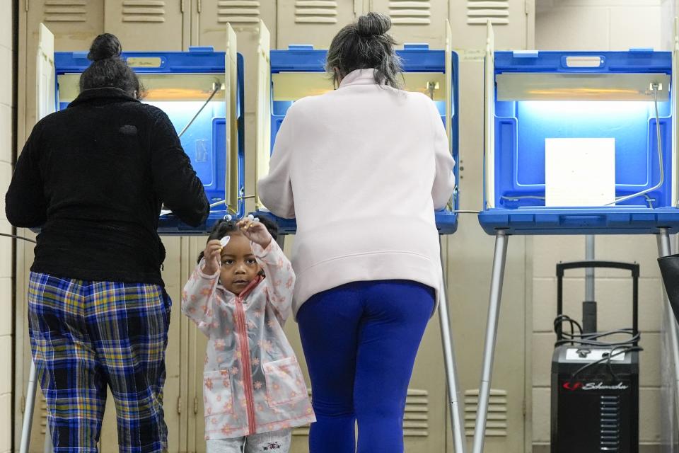 Three-year old- K-Lee waits as her mother Heather Ramsey votes during the Spring election Tuesday, April 2, 2024, in Milwaukee, Wis. (AP Photo/Morry Gash)