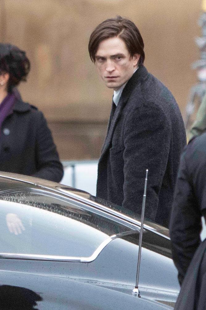 Robert Pattinson filming The Batman with side-parted curtains.