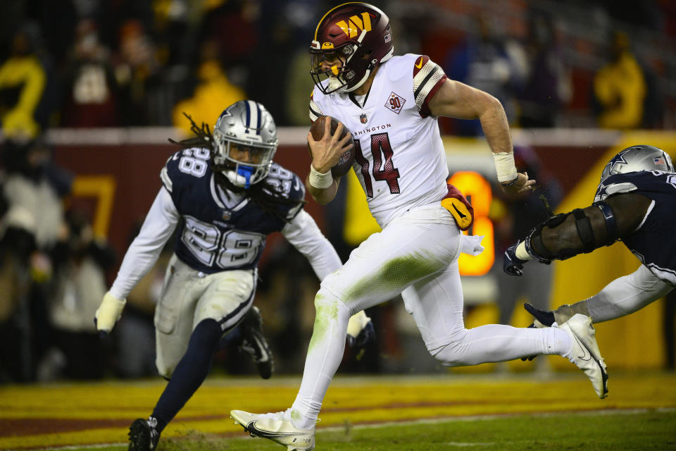 Washington Commanders quarterback Sam Howell (14) runs into the end zone to score a touchdown against the Dallas Cowboys during the second half an NFL football game, Sunday, Jan. 8, 2023, in Landover, Md. (AP Photo/Nick Wass)