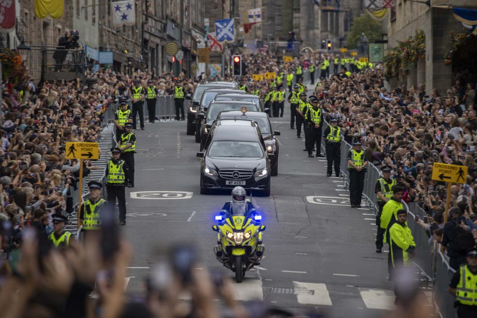 EDINBURGH, SCOTLAND - SEPTEMBER 11: Crowds of public gather for the Queen's funeral cortege proceeding down The Royal Mile towards Holyroodhouse on September 11, 2022 in Edinburgh, Scotland. On April 21, 1926, Elizabeth Alexandra Mary Windsor was born in Mayfair, London's Bruton Street. Following the passing of her father, King George VI, she wed Prince Philip in 1947, and on February 6, 1952, she succeeded him as monarch of the United Kingdom and the Commonwealth. King Charles III succeeded Queen Elizabeth II after she passed away on September 8, 2022, at Balmoral Castle in Scotland. (Photo by Rasid Necati Aslim/Anadolu Agency via Getty Images)