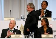 President Luiz Inacio Lula da Silva of Brazil passes behind Brazilian athlete Barbara Leoncio (R) and Brazilian former Olympic athlete and IOC member, Joao Havelange, as he walks to the podium to present the city of Rio de Janeiro's candidature for the 2016 Olympic Games to International Olympic Committee (IOC) members during the 121st IOC session in Copenhagen October 2, 2009. REUTERS/Denis Balibouse/File photo