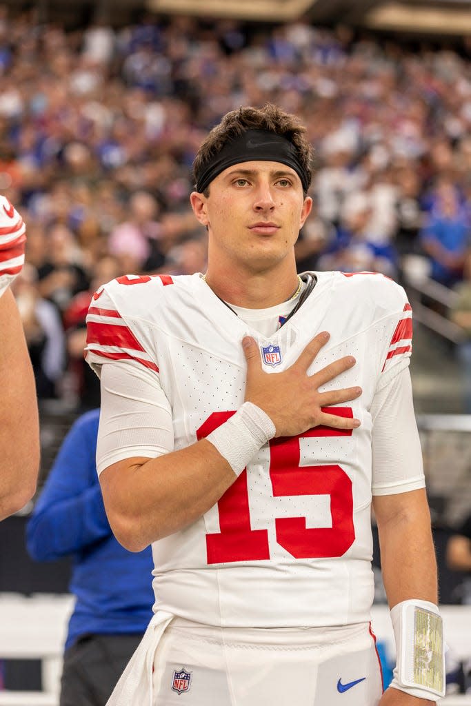 New York Giants quarterback Tommy DeVito (15) stands for the National Anthem before playing against the Las Vegas Raiders in an NFL football game, Sunday, Nov. 5, 2023, in Las Vegas, NV. Raiders defeat the Giants 30-6. (AP Photo/Jeff Lewis)