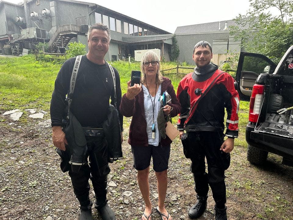 Tafton Dive/Rescue Capt. Charles Simone, at left, and Lt. Matt Forsythe at right, with a woman whose cell phone dropped in Lake Wallenpaupack in July 2023. These divers went in and recovered it. Both Tafton and Ledgedale dive teams frequently make these types of recoveries, which have included such things as wedding rings, phones, wallets, key rings, watches and sunglasses.