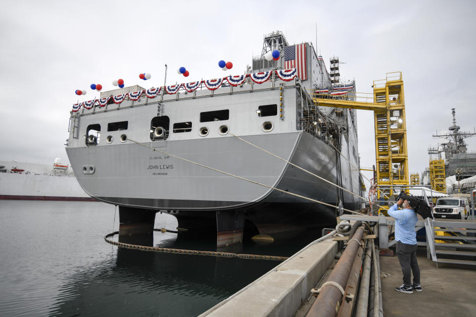 A television cameraman videotapes the USNS John Lewis before a christening ceremony Saturday July 17, 2021, in San Diego. (AP Photo/Denis Poroy)