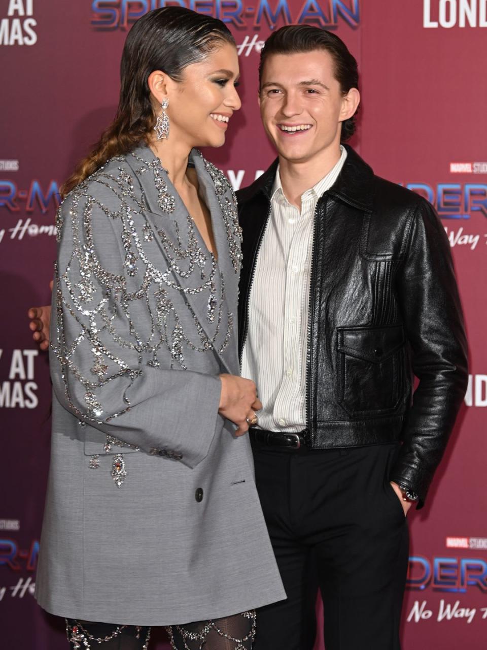 Zendaya and Tom in December 2021 smiling at each other on the red carpet