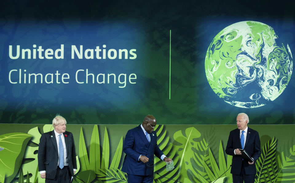 British Prime Minister Boris Johnson, President of Congo Felix Tshisekedi and President Joe Biden stand before speaking at a session on Action on Forests and Land Use, during the UN Climate Change Conference COP26 in Glasgow, Scotland, Tuesday, Nov. 2, 2021. (Erin Schaff/The New York Times via AP, Pool)