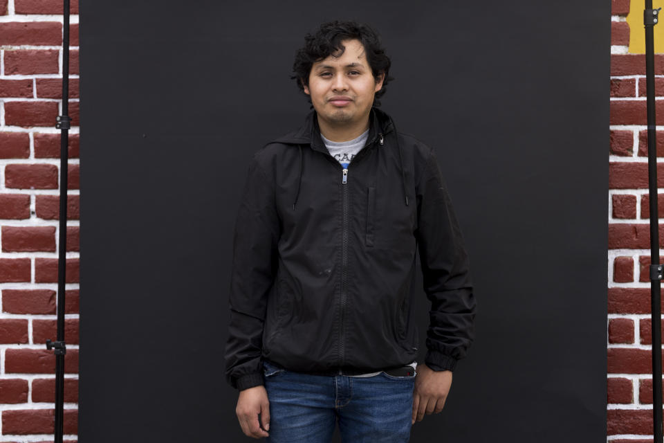 Aníbal Simón poses for portraits in San Juan Comalapa, Guatemala, Tuesday, June 20, 2023. The 29-year-old call center worker said he was still deciding between two candidates, ahead of June 25 elections. (AP Photo/Moises Castillo)