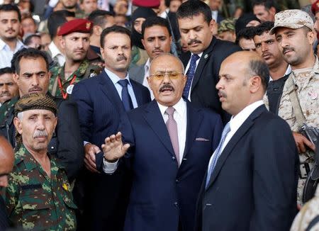 Yemen's former President Ali Abdullah Saleh (in red neck tie) is surrounded by guards as he attends a rally held to mark the 35th anniversary of the establishment of his General People's Congress party in Sanaa, Yemen August 24, 2017. Picture taken August 24, 2017. REUTERS/Khaled Abdullah