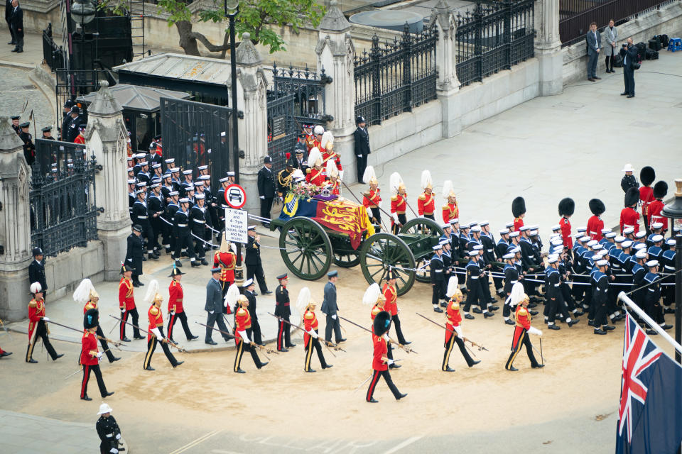 The State Gun Carriage carries the coffin of Queen Elizabeth II, draped in the Royal Standard with the Imperial State Crown and the Sovereign's orb and sceptre, as it leaves Westminster Hall for the State Funeral at Westminster Abbey, London. Picture date: Monday September 19, 2022.