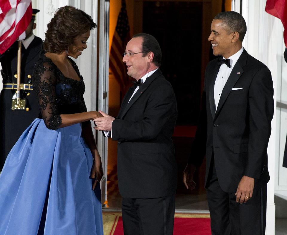 First lady Michelle Obama, left, and President Barack Obama welcome French President François Hollande for a State Dinner at the North Portico of the White House on Tuesday, Feb. 11, 2014, in Washington. (AP Photo/ Evan Vucci)