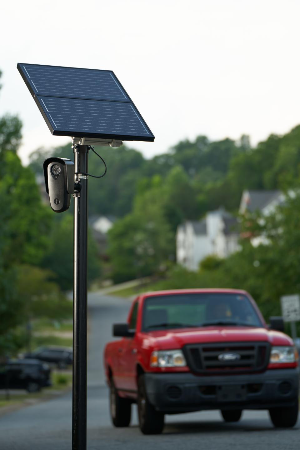 Flock safety cameras on a pole with a solar panel, which powers the license plate reader.