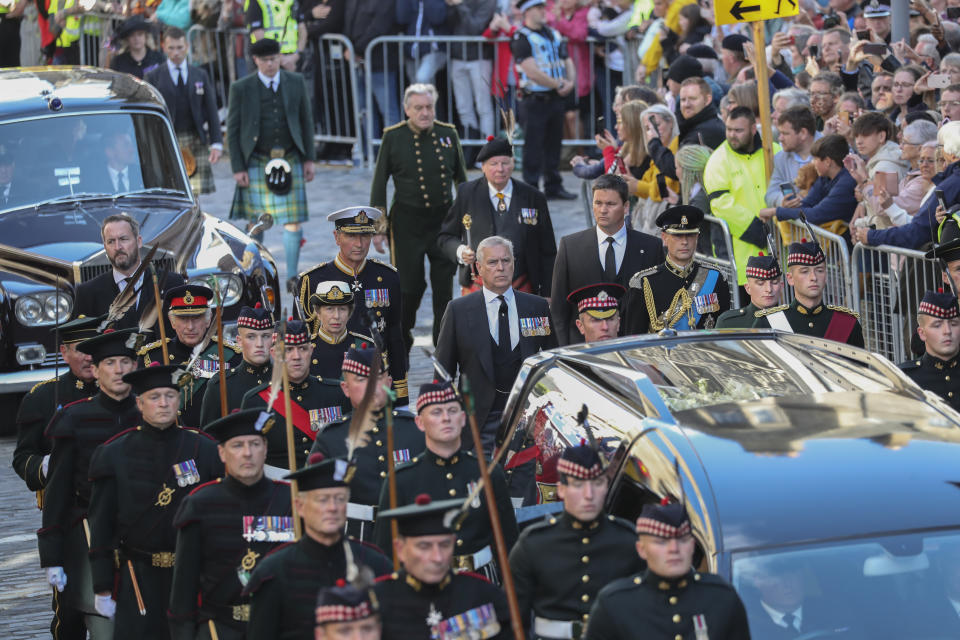 The procession with the coffin of Queen Elizabeth II, followed by, from left, King Charles III, Princess Anne, Prince Andrew, and Prince Edward, heads up the Royal Mile to St Giles' Cathedral in Edinburgh, Monday, Sept. 12, 2022. Britain's longest-reigning monarch who was a rock of stability across much of a turbulent century, died Thursday Sept. 8, 2022, after 70 years on the throne. She was 96. (AP Photo/Scott Heppell)