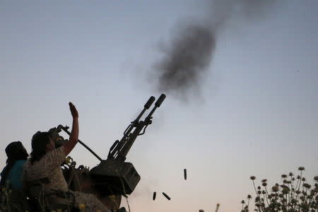 Tajammu Al-Ezza brigade fighters fire an anti-aircraft weapon towards what activists said were helicopters loyal to Syria's president Bashar Al-Assad located in Hama countryside May 6, 2015. REUTERS/Mohamad Bayoush