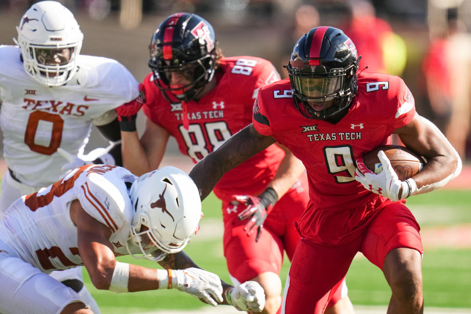 LUBBOCK, TEXAS - SEPTEMBER 24: Jerand Bradley #9 of the Texas Tech Red Raiders rushes against defender Jerrin Thompson #28 of the Texas Longhorns during the second half at Jones AT&T Stadium on September 24, 2022 in Lubbock, Texas. (Photo by Josh Hedges/Getty Images)