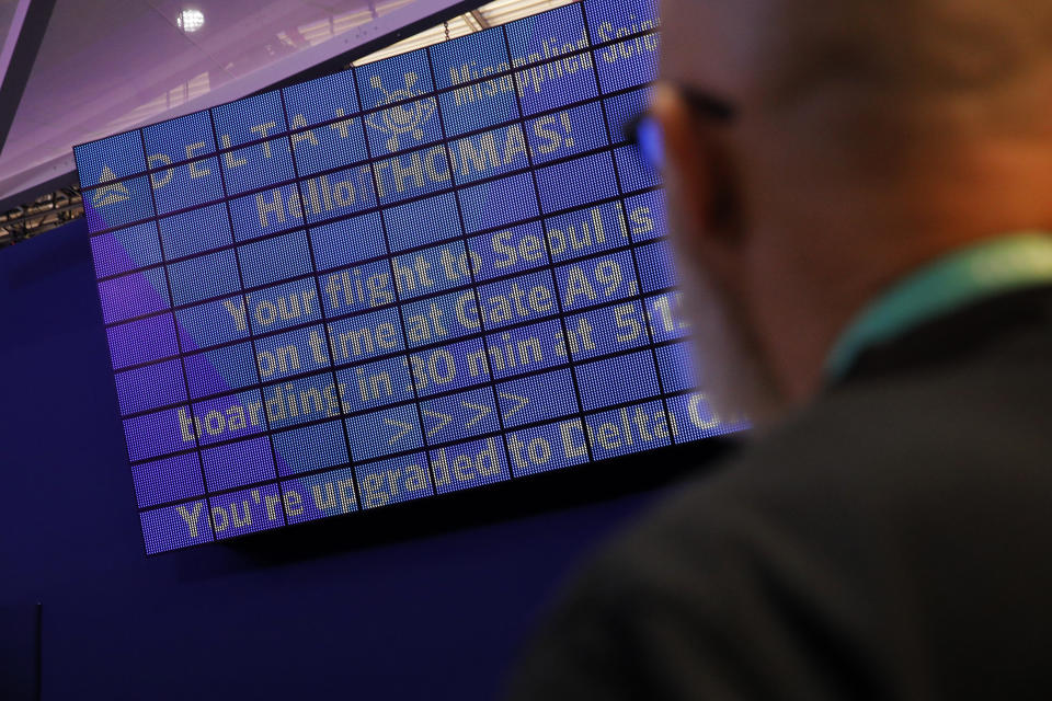 An attendee looks at a screen with information unique to him the parallel reality experience at the Delta Air Lines booth during the CES tech show, Tuesday, Jan. 7, 2020, in Las Vegas. The parallel reality screens are a type of personalized signage that shows custom messages of flight information to multiple travelers simultaneously. (AP Photo/John Locher)