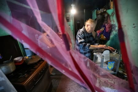 A local resident casts a vote into a mobile ballot box during Ukraine's parliamentary election in Kiev Region