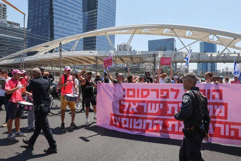 Policías se despliegan mientras familiares y simpatizantes de los israelíes retenidos como rehenes por militantes palestinos en la Franja de Gaza desde octubre celebran una concentración pidiendo su liberación en Tel Aviv el 2 de septiembre de 2024, en medio del conflicto en curso en la Franja de Gaza entre Israel y el movimiento militante palestino Hamás. (Foto de Jack GUEZ / AFP)