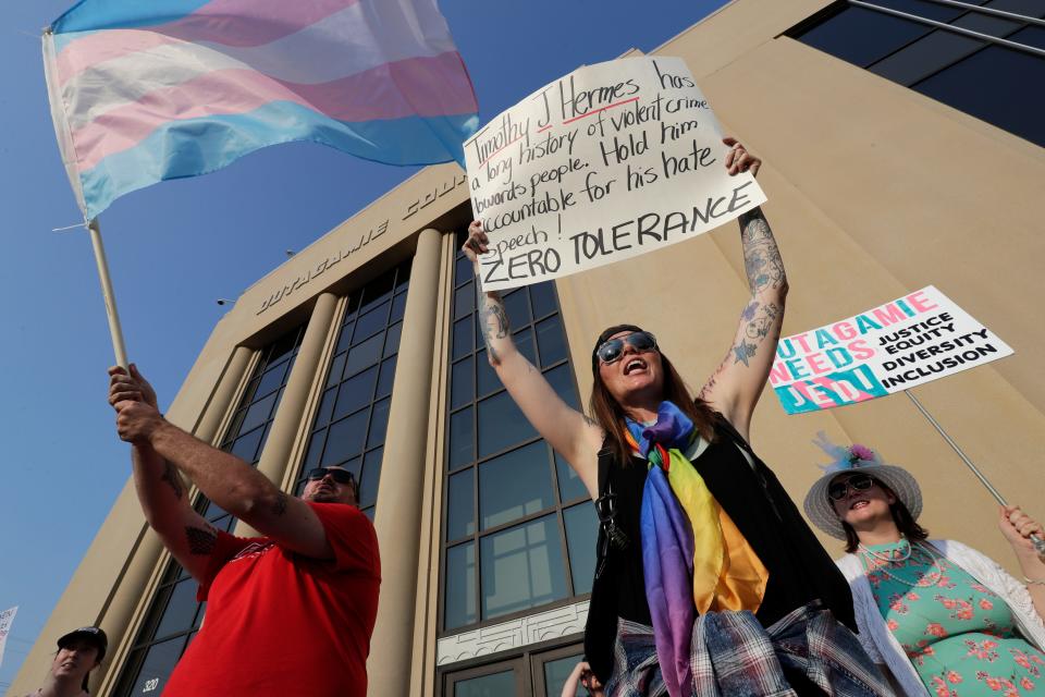 Transgender rights activists and citizens protest prior to the start of an Outagamie County Board meeting at the Outagamie County Government Center on Tuesday, May 23, 2023, in Appleton, Wis. At a May 9 county board meeting, board member Timothy Hermes made transphobic comments regarding transgender people and their use of bathrooms that align with their gender, calling them "disgusting."