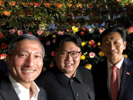 Singapore's Foreign Minister Vivian Balakrishnan, North Korean leader Kim Jong Un, and Singapore's Education Minister Ong Ye Kung pose for a photo in Singapore June 11, 2018, in this photo obtained from social media. MANDATORY CREDIT. Vivian Balakrishnan's Twitter page/via REUTERS