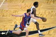 Detroit Pistons guard Svi Mykhailiuk (19) pokes the ball away from Orlando Magic forward Al-Farouq Aminu, right, during the second half of an NBA basketball game, Tuesday, Feb. 23, 2021, in Orlando, Fla. (AP Photo/Phelan M. Ebenhack)