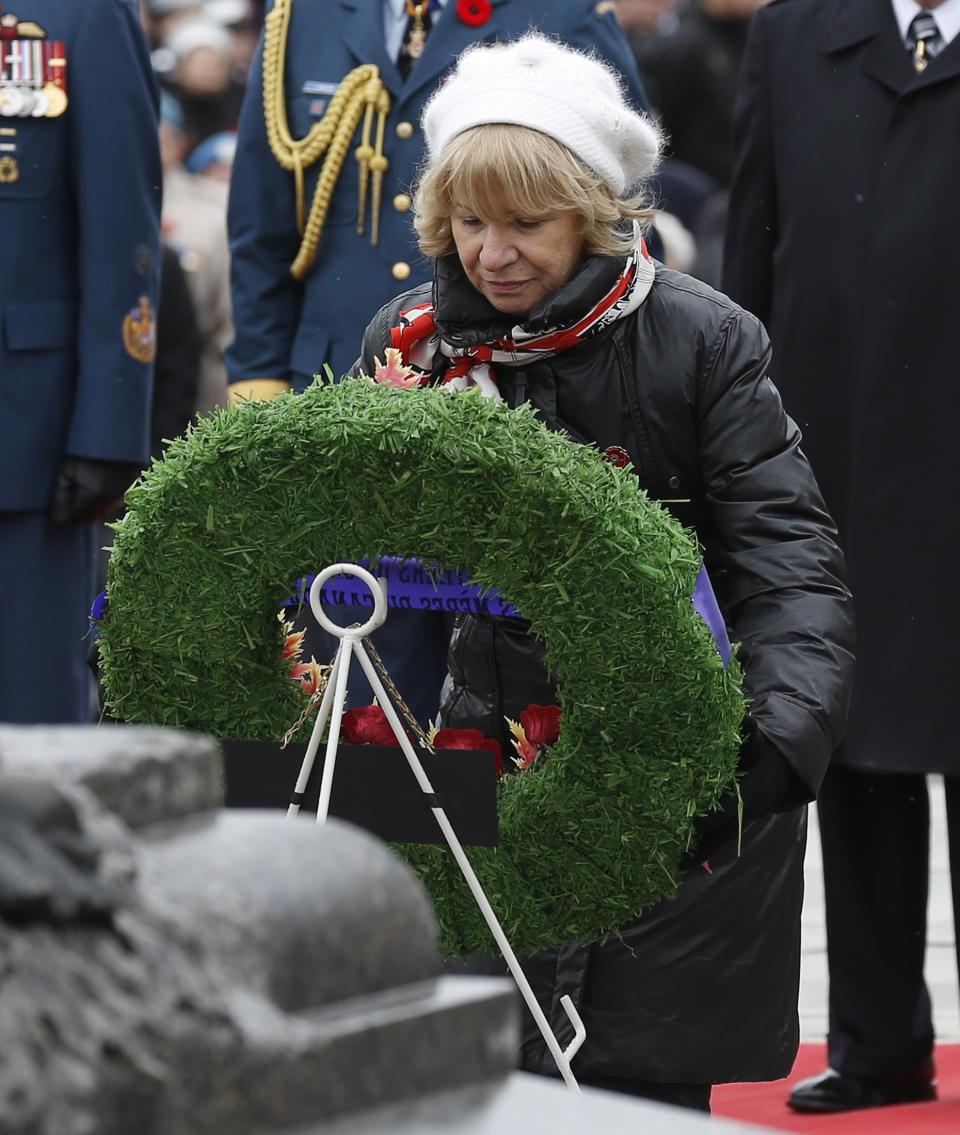 Silver Cross Mother Niki Psiharis lays a wreath during the Remembrance Day ceremony at the National War Memorial in Ottawa November 11, 2013. Psiharis, whose son Sergeant Chris Karigiannis was killed while serving in Afghanistan in 2007, was chosen Silver Cross Mother to represent all Canadian mothers who have lost children in service to their country. REUTERS/Chris Wattie (CANADA - Tags: MILITARY ANNIVERSARY)