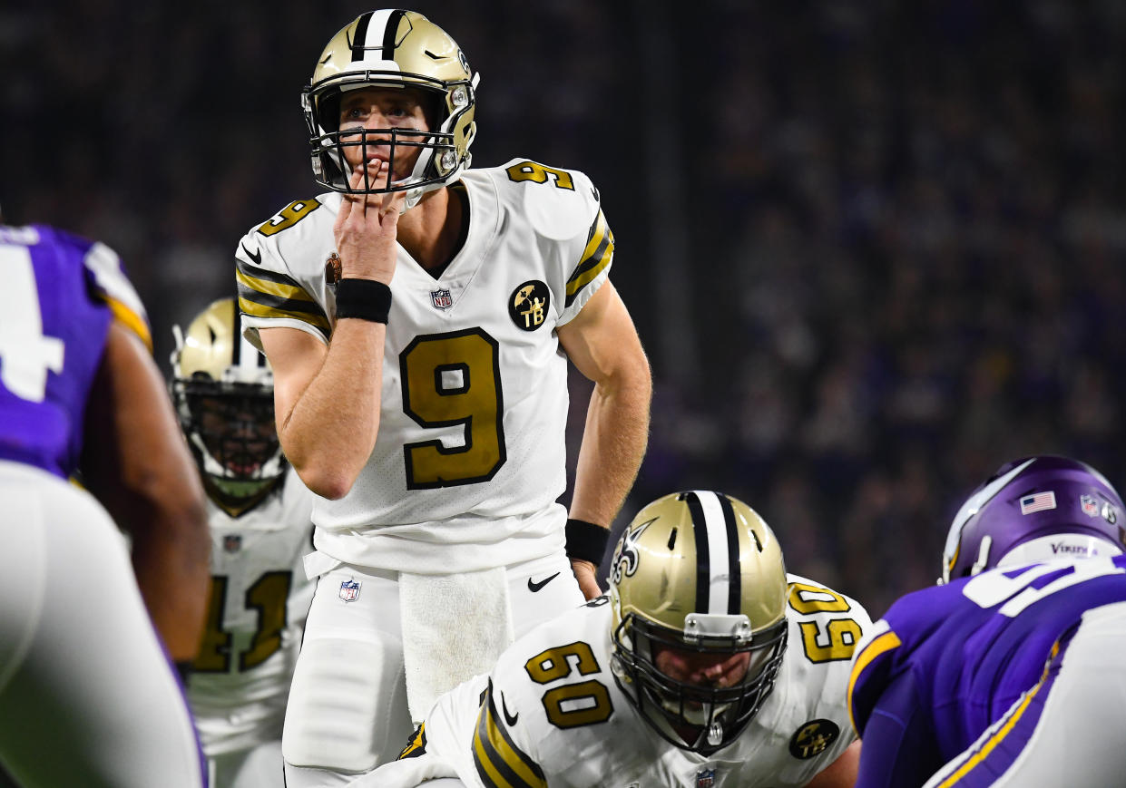 Drew Brees licks his hand while waiting for a snap.