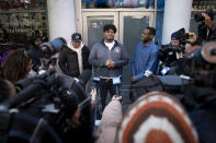 Darius Conner, son of business owner Roland, speaks to waiting customers and media members outside the Smacked "pop up" cannabis dispensary location they operate, Tuesday, Jan. 24, 2023, in New York. The store is the first Conditional Adult-Use Retail Dispensary (CAURD) opening since the legalization of cannabis that is run by businesspeople who had been criminalized by cannabis prohibition. (AP Photo/John Minchillo)
