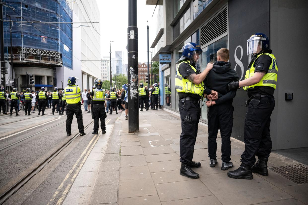 Manchester, 3 August 2024. A man is detained during far-right protests in Manchester. The demonstration comes as 30 other cities around the UK face similar protests, including Liverpool, Bristol, Hull, and more. Credit: Benjamin Wareing/Alamy Live News