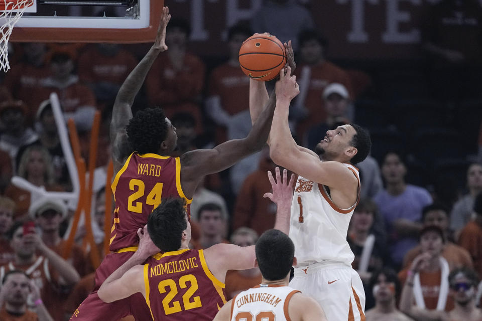 Iowa State forward Hason Ward (24) and Texas forward Dylan Disu (1) reach for a rebound during the first half of an NCAA college basketball game Tuesday, Feb. 6, 2024, in Austin, Texas. (AP Photo/Eric Gay)