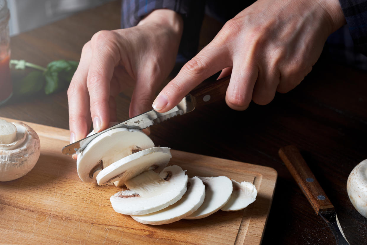 Cooking Italian Vegetarian Pizza With Vegetables And Mushrooms At Home, On A Wooden Table. The Woman Slices The Mushrooms. Step-by-step instructions, Do it Yourself. Step 5.