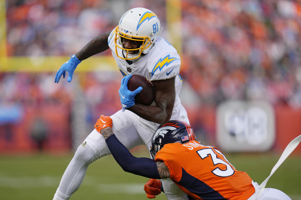 Los Angeles Chargers wide receiver Mike Williams (81) is hit by Denver Broncos safety Justin Simmons (31) after making a catch during the first half of an NFL football game in Denver, Sunday, Jan. 8, 2023. (AP Photo/Jack Dempsey)