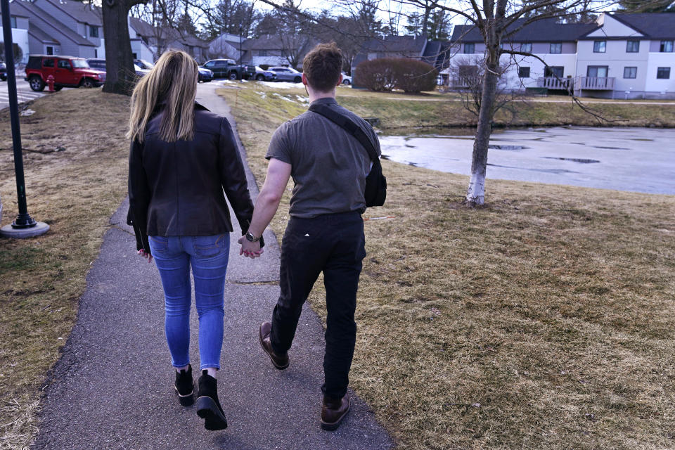 Anna Craven, left, walks with Ryan Johnson outside their home, Friday, Feb. 10, 2023, in Nashua, N.H. The recently engaged couple have also established a transparent financial relationship including being open about individual budgets and having mutual financial goals. Talking about money with your significant other might not be the most romantic topic, but it's a key element of a healthy relationship. (AP Photo/Charles Krupa)