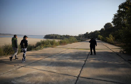 People walk next the site where Bulgarian TV journalist Viktoria Marinova was killed on Saturday, in Ruse, Bulgaria, October 9, 2018. REUTERS/Stoyan Nenov