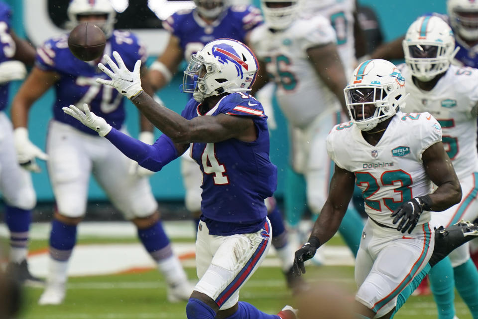 Buffalo Bills wide receiver Stefon Diggs (14) catches a pass ahead of Miami Dolphins cornerback Noah Igbinoghene (23), during the first half of an NFL football game, Sunday, Sept. 20, 2020 in Miami Gardens, Fla. (AP Photo/Wilfredo Lee)