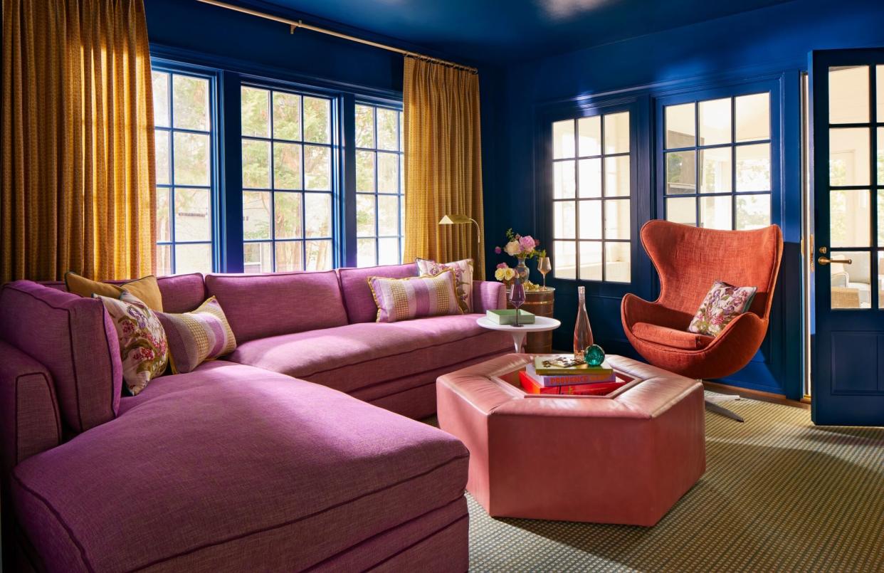 Dark blue den with purple sectional