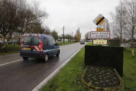 A French National Gendarmerie car drives past the road sign at the entry of Le Bosc-Roger-en-Roumois, northern France, November 17, 2014. REUTERS/Philippe Wojazer