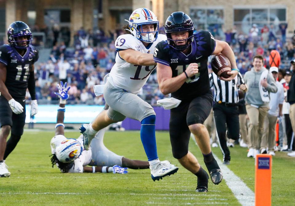 TCU quarterback Max Duggan (15) is defended by  Kansas linebacker Gavin Potter (19) during the second half of their 2012 game  at Amon G. Carter Stadium.