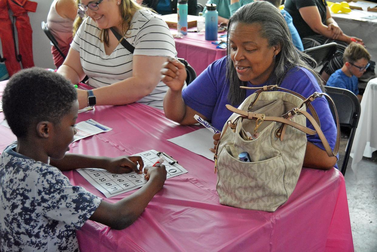 Kawhi and Yolanda Smith play bingo Thursday during Central Missouri Community Action's Bingo for Babies fundraiser at a space in the Arcade District adjacent to Irene's Bbq and Witches and Wizards Arcade.