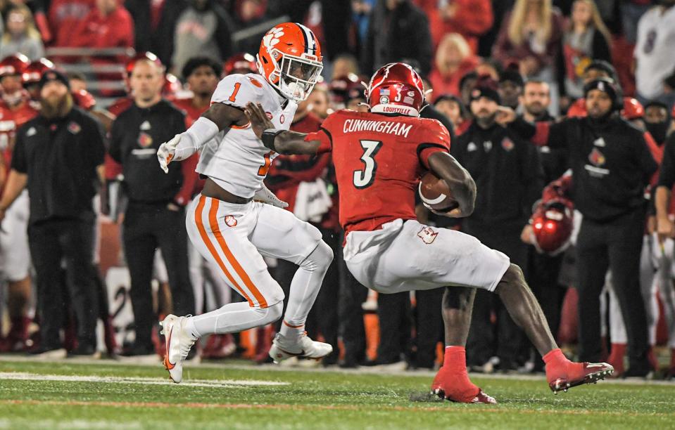 Clemson safety Andrew Mukuba (1) corners Louisville quarterback Malik Cunningham (3) short of a first down on a fourth down play, during the fourth quarter at Cardinal Stadium in Louisville, Kentucky Saturday, November 6, 2021.