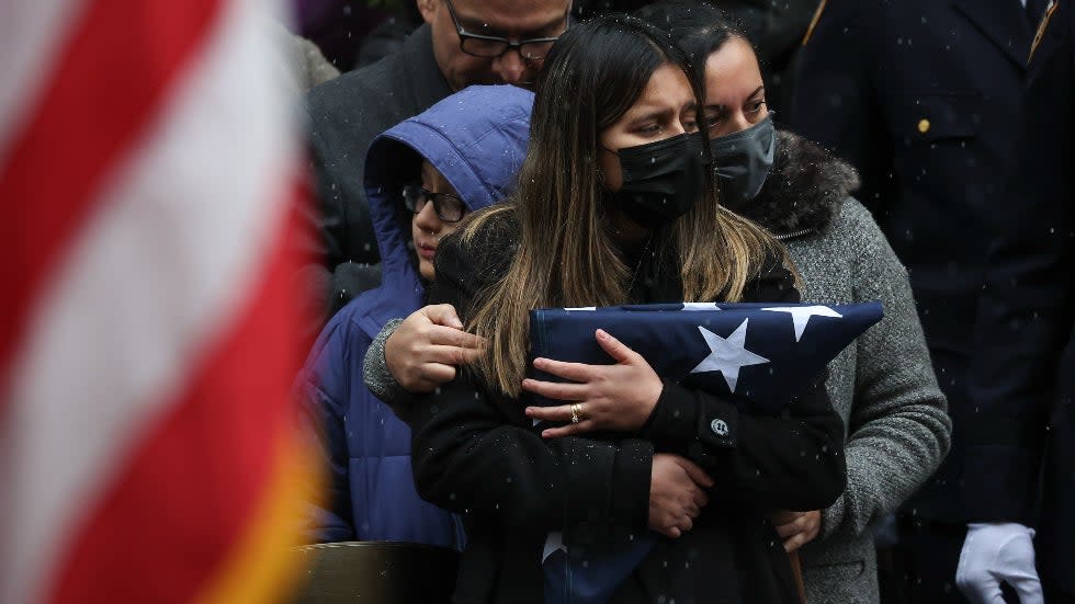 Dominique Rivera, the widow of NYPD officer Jason Rivera watches as his casket is loaded into a hearse outside St. Patrick's Cathedral