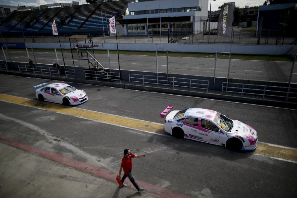 Vitarti Girl's Team drivers Karina Dobal, right, and Rocio Migliore leave the pits in their race cars for a practice session at the Oscar y Juan Galvez track in Buenos Aires, Argentina, Friday, April 2, 2021. They are the first all-female team in Argentina's motorsport history. (AP Photo/Natacha Pisarenko)